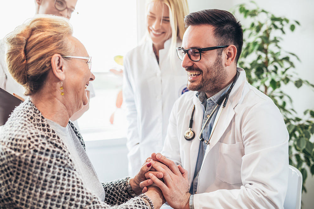 young doctor visiting senior patient