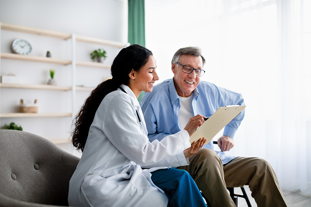 doctor talking with male patient reviewing patient chart